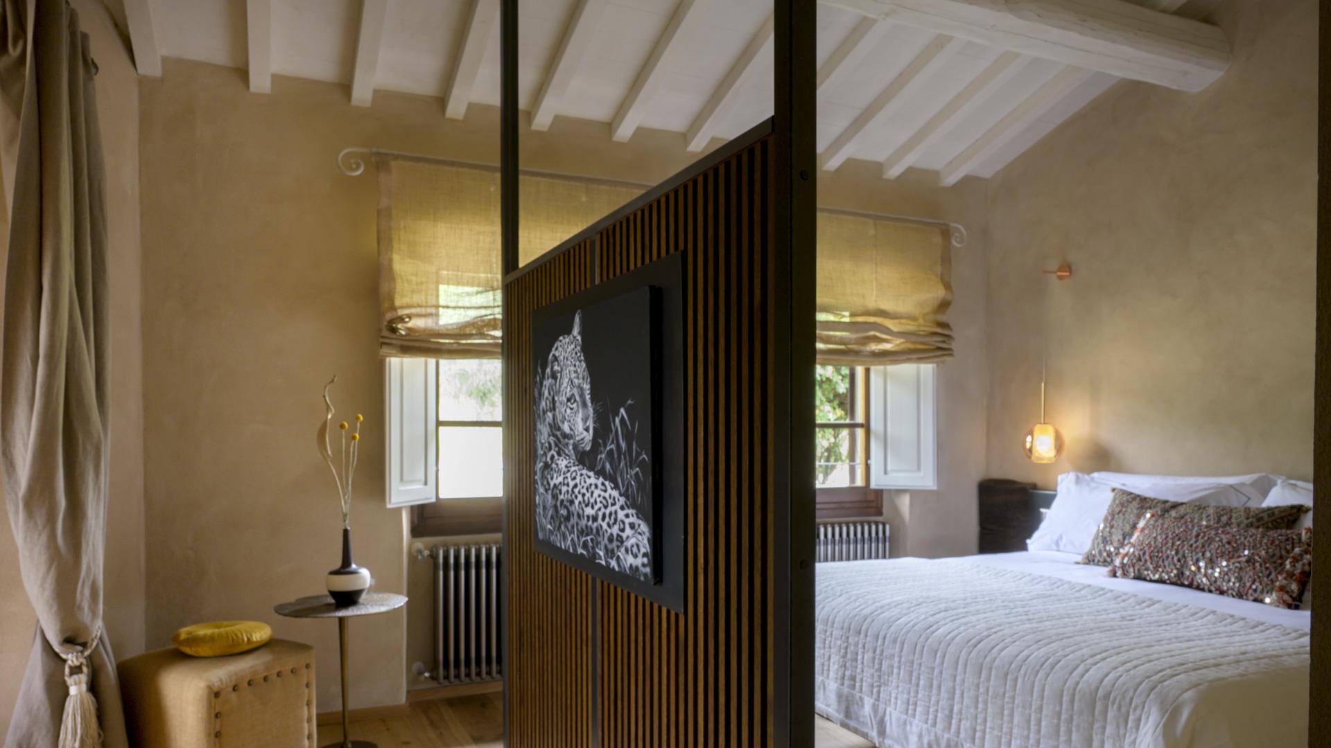Cozy room with white bed, leopard art, warm and relaxing atmosphere.