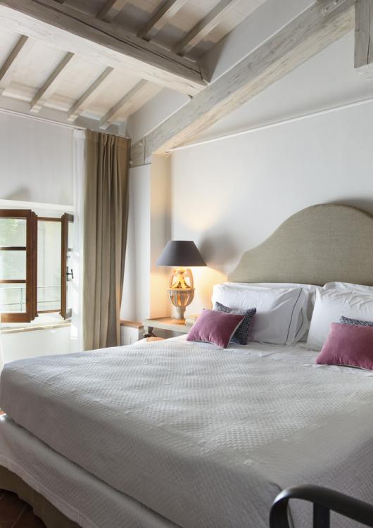 Cozy bedroom with a double bed, soft lighting, and elegant furnishings.