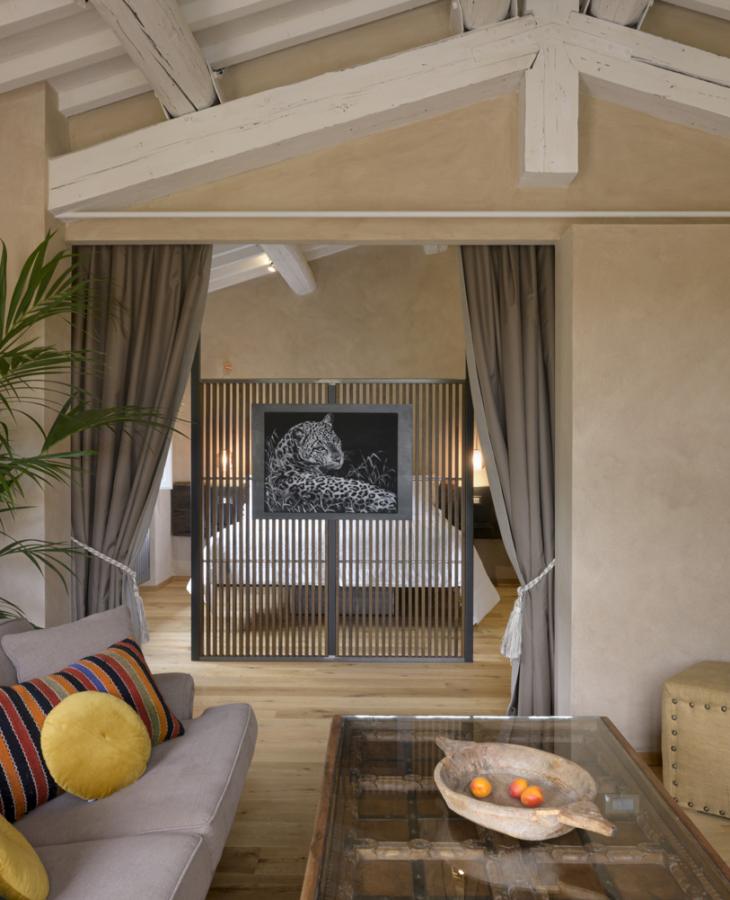 Cozy living room with colorful pillows and elegant art, warm and relaxing atmosphere.