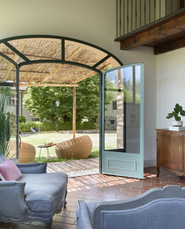 Bright interior, elegant furnishings, view of a green and cozy garden.
