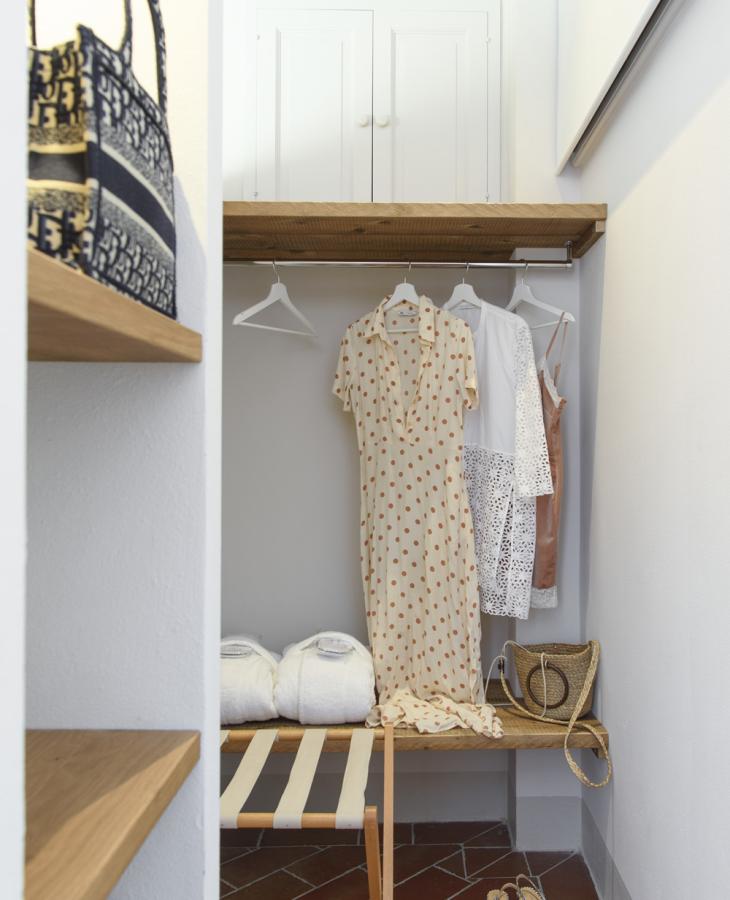 A cozy closet with summer dresses, elegant shoes, and soft bathrobes.